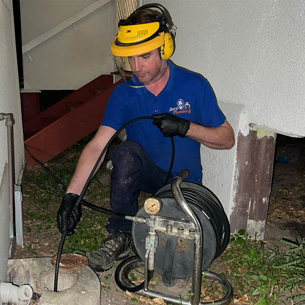 Rhys using hydrojet outside to unblock sewerage system