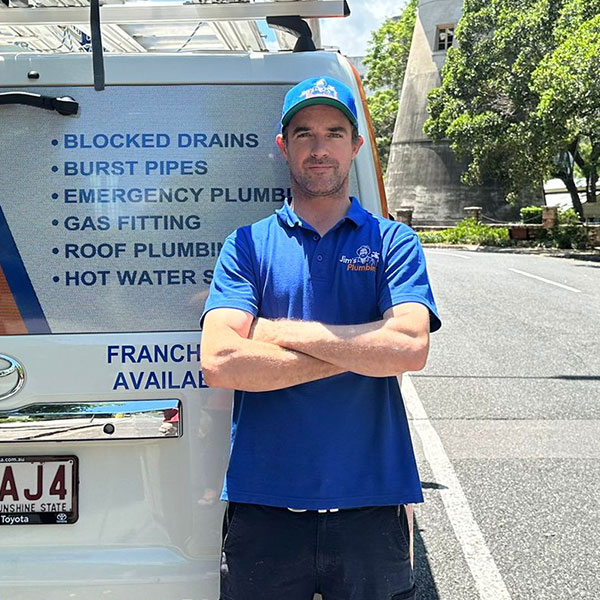 Rhys arms crossed infront of Spring Hill windmill, Brisbane CBD