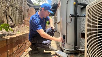 Plumber fixing Brisbane outdoor storge tank gas hot water system