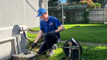 Rhys unblocking outdoor drain with hydrojet in Margate, Brisbane