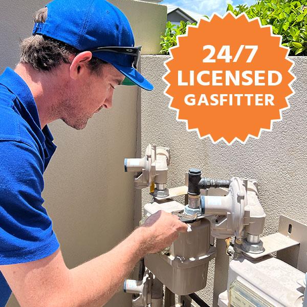 Plumber working on mains gas boxes at front property